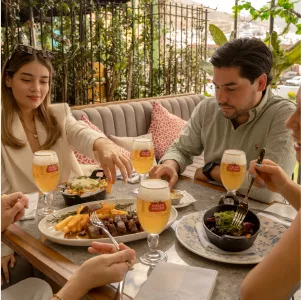 People eating food and drinking Stella People eating food and drinking Stella